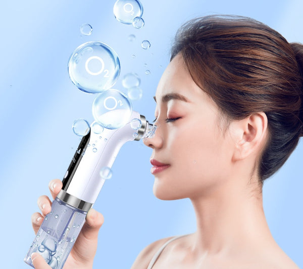 Woman using a facial cleansing device with bubbles on a light blue background