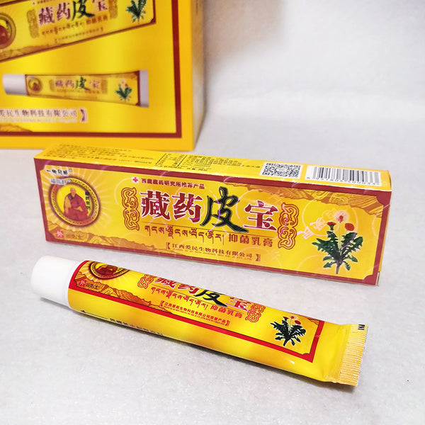 Two boxes and a tube of 'Cang Yu Pi Bao' cream on a white background