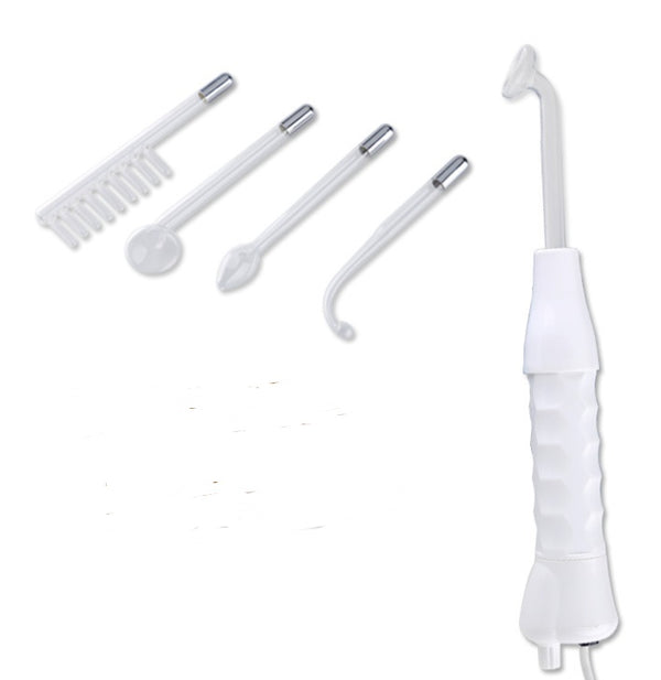 Set of dental tools including a white handheld device and various attachments on a white background.