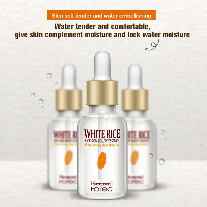 White Rice skincare essence bottles with gold caps on a light gray background