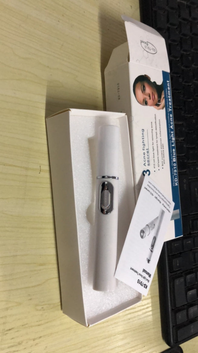 White electronic device with packaging and user manual on a wooden surface