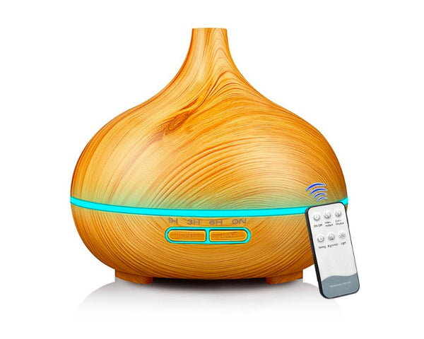 Wooden-textured diffuser with a remote control on a white background