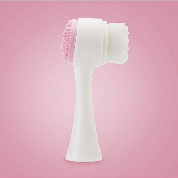 White facial cleansing brush with pink bristle head on a pink background