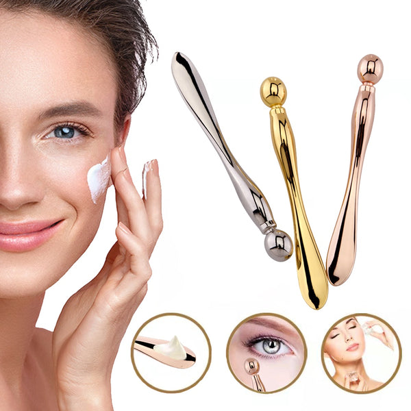 Woman applying cream with three metallic facial massagers on a white background