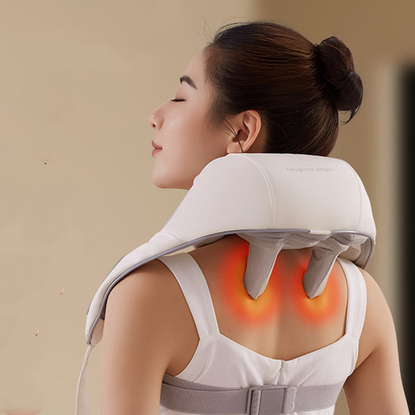 Woman using a neck and shoulder massager with glowing red lights on a beige background